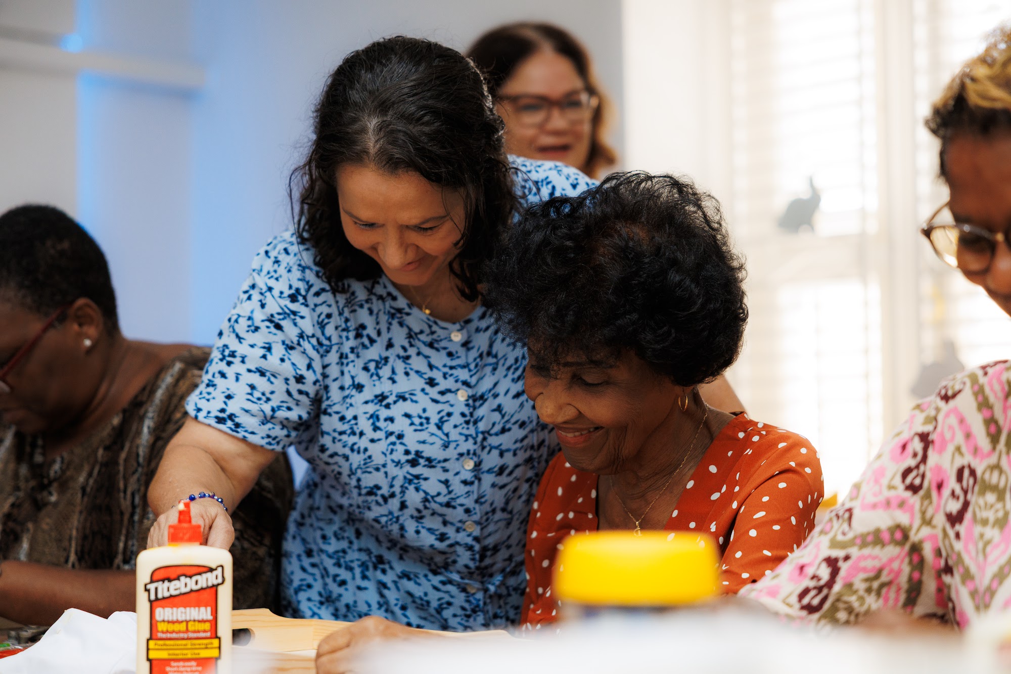 Participants working together at a table during a PWF psychosocial support group session