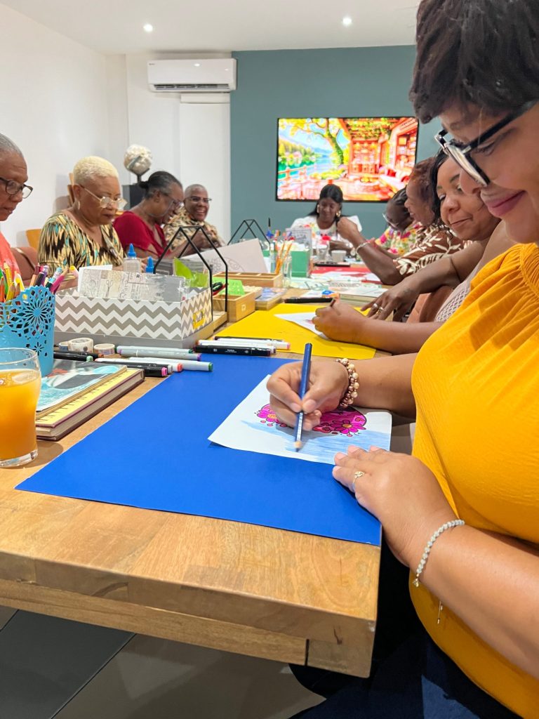 Participants colouring and drawing together at a PWF therapy and recreation session