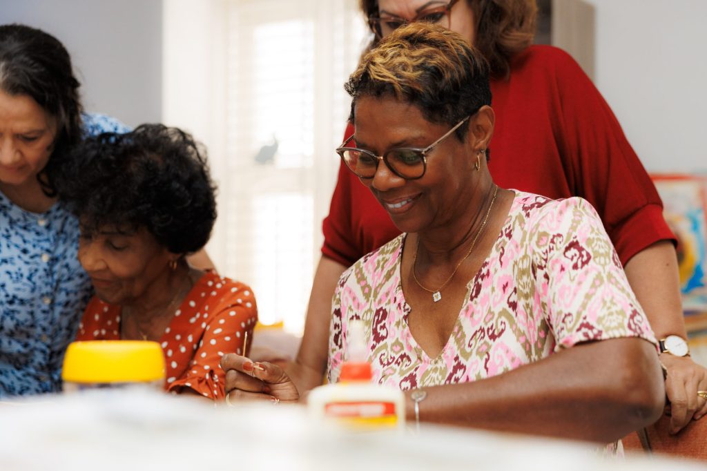 Women working on a craft project together at a PWF therapy and recreation session